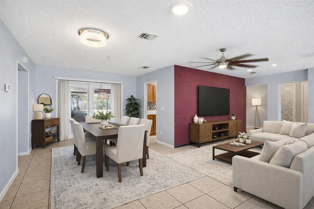 1071 Angora Street Deltona, FL 32725 - Photo 2 of 45 a living room with furniture and a flat screen tv