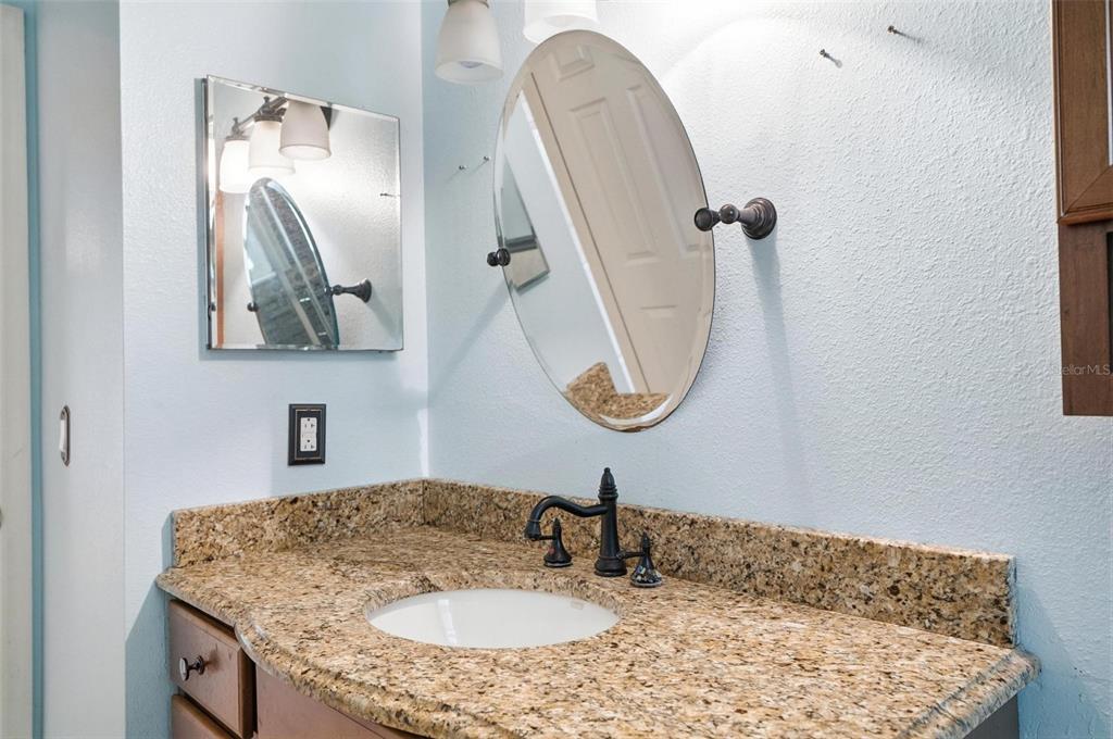 1071 Angora Street Deltona, FL 32725 - Photo 31 of 45 a bathroom with a sink vanity and a mirror
