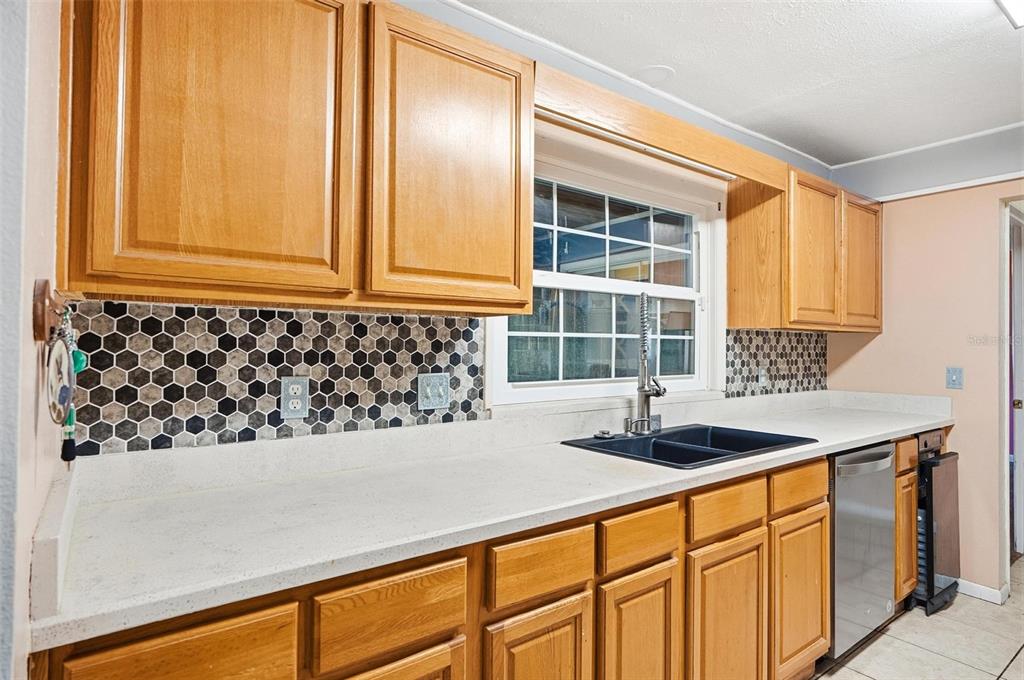 1071 Angora Street Deltona, FL 32725 - Photo 6 of 45 a kitchen with granite countertop a sink and a window