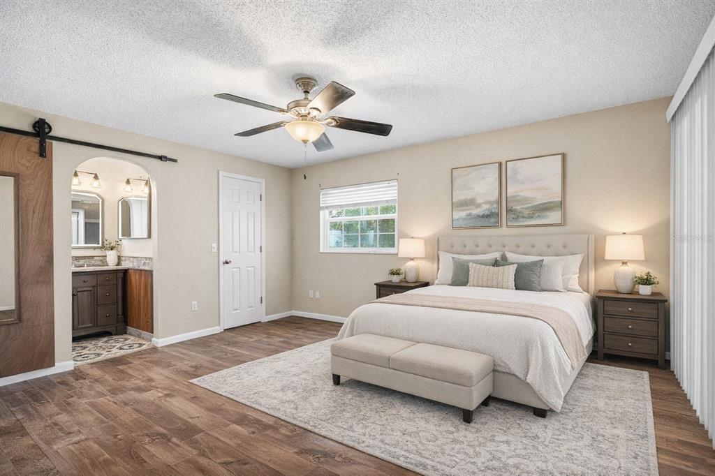 1071 Angora Street Deltona, FL 32725 - Photo 9 of 45 a bedroom with a large bed and a chandelier