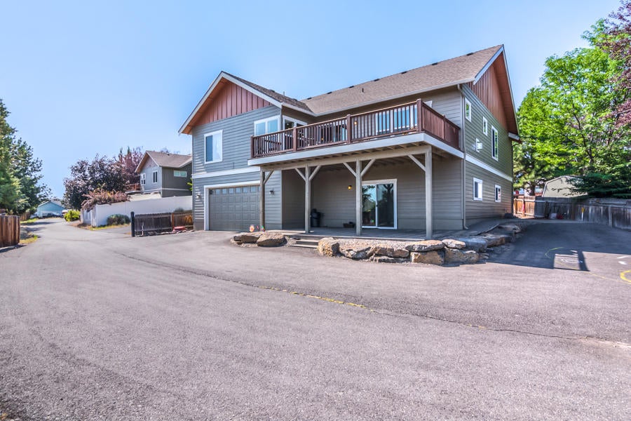 View of home from the rear/alley access and the flat lot allows for plenty of parking including RV and boats!