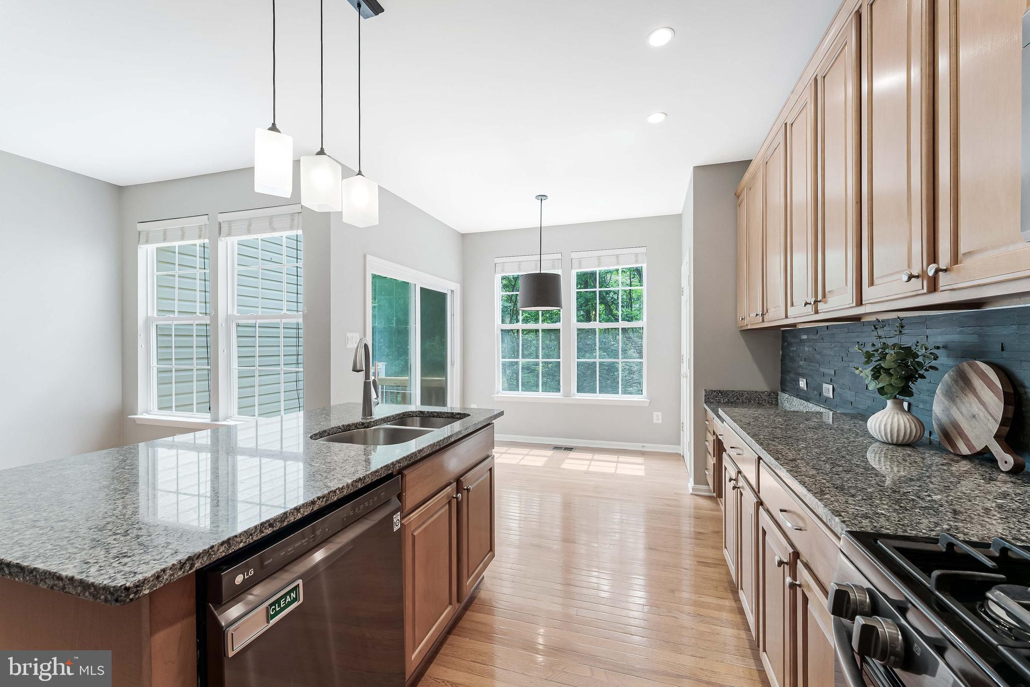 43103 Forest Edge Square Broadlands, VA 20148 - Photo 17 of 57 a kitchen with granite countertop a sink and a window