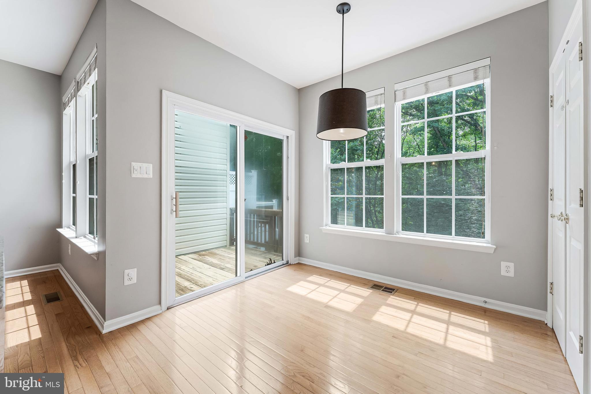 43103 Forest Edge Square Broadlands, VA 20148 - Photo 20 of 57 a view of an empty room with wooden floor and a window