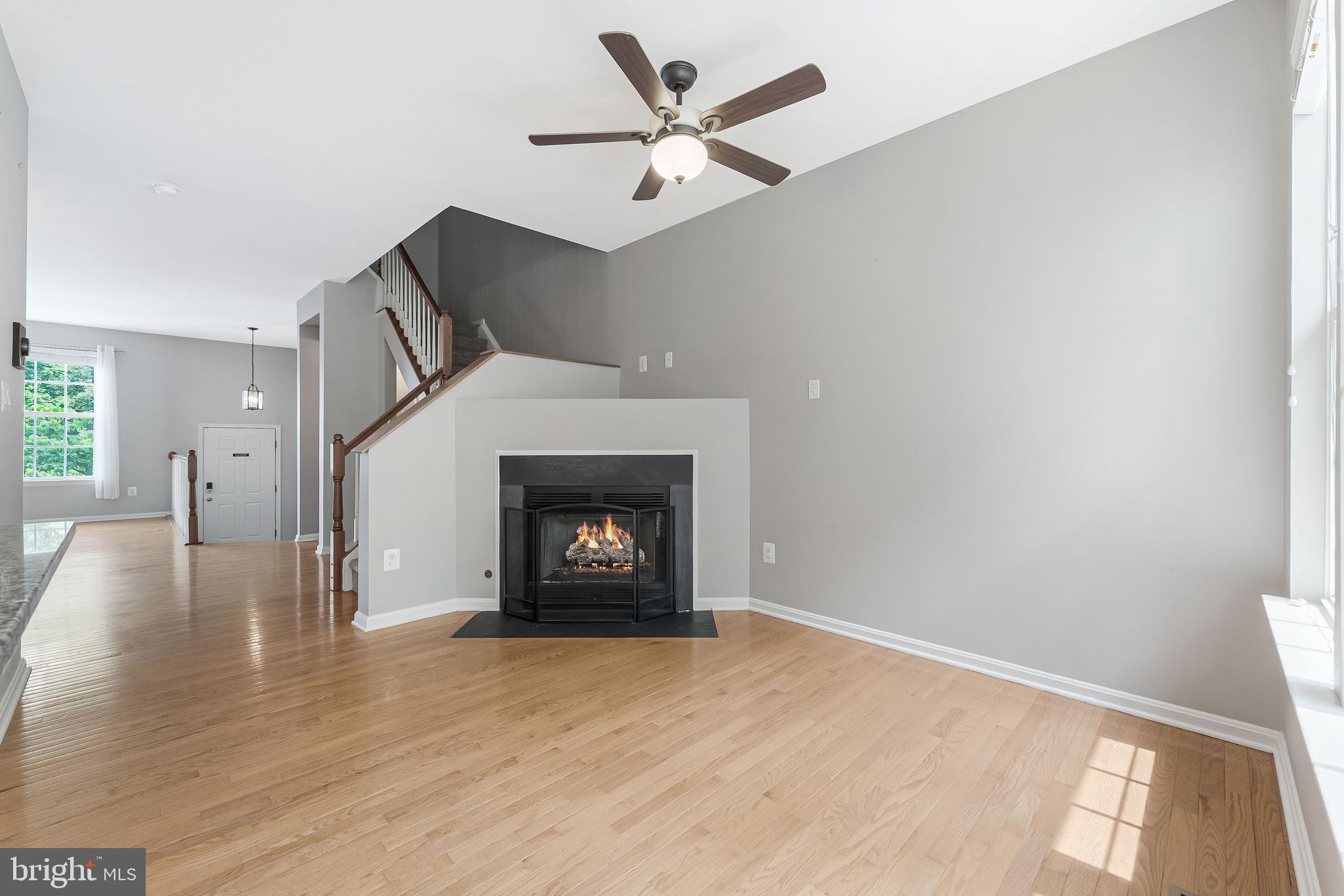 43103 Forest Edge Square Broadlands, VA 20148 - Photo 23 of 57 a living room with furniture and a fireplace