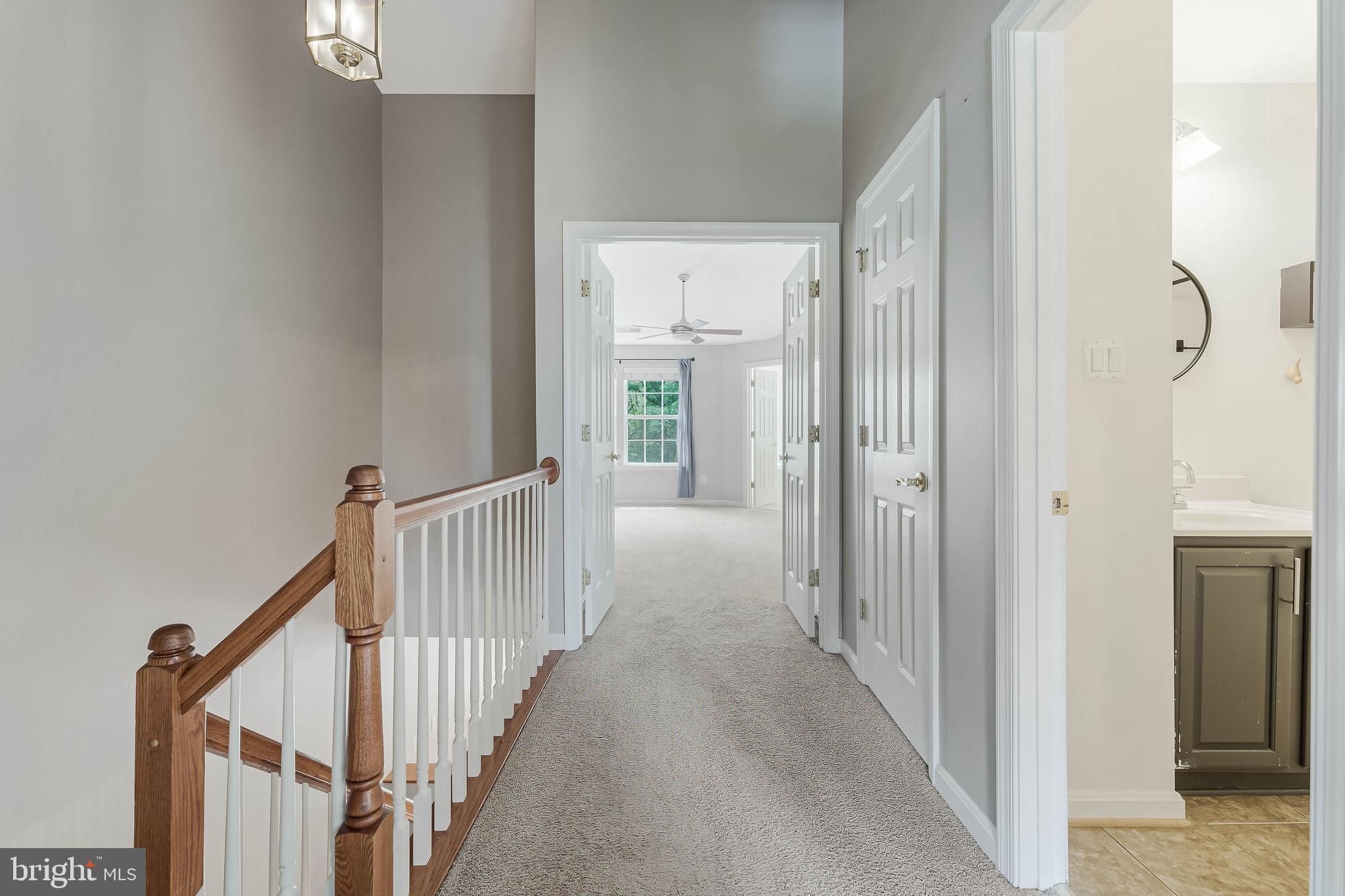 43103 Forest Edge Square Broadlands, VA 20148 - Photo 27 of 57 a view of a hallway with wooden floor and staircase