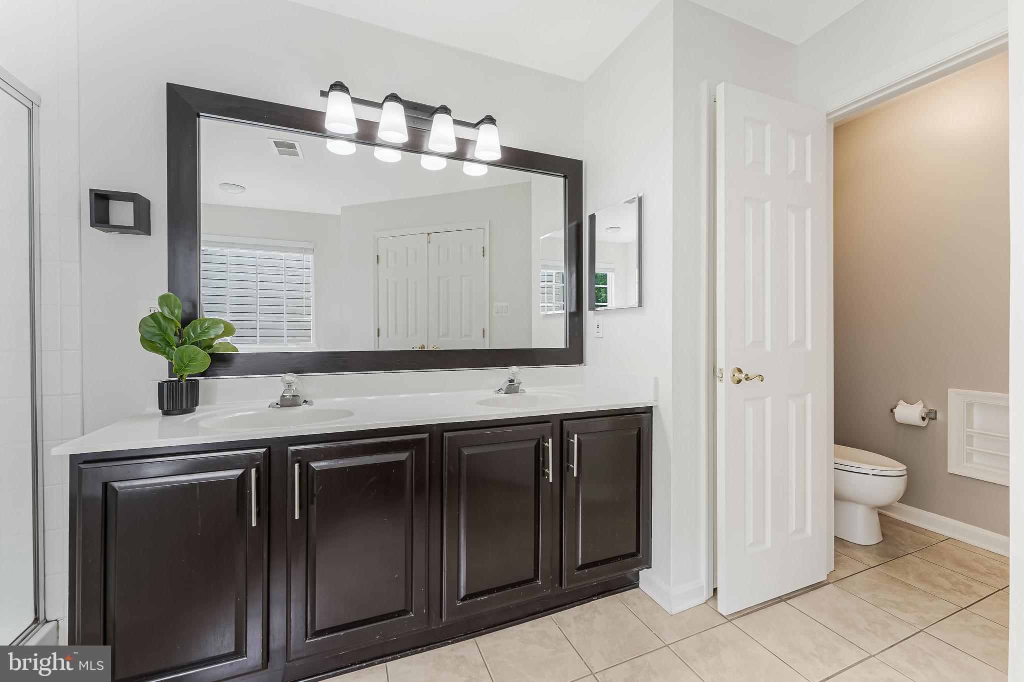 43103 Forest Edge Square Broadlands, VA 20148 - Photo 33 of 57 a bathroom with a sink and a mirror