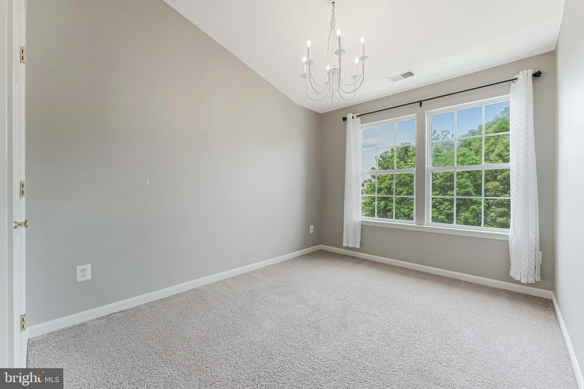 43103 Forest Edge Square Broadlands, VA 20148 - Photo 40 of 57 en empty room with windows and chandelier