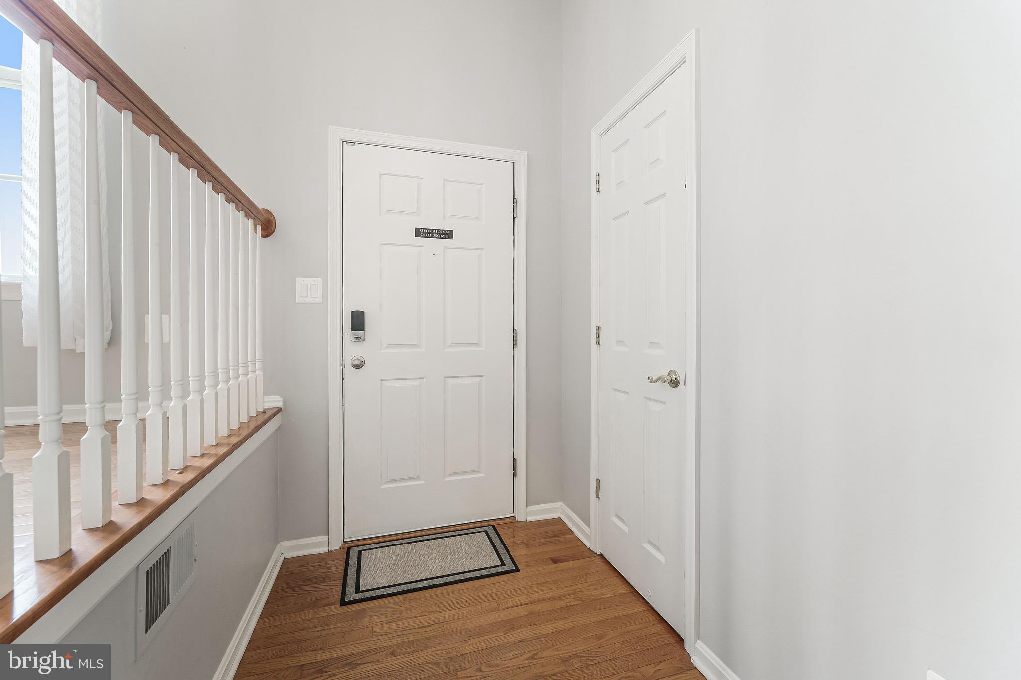 43103 Forest Edge Square Broadlands, VA 20148 - Photo 7 of 57 a view of a hallway with wooden floor and staircase