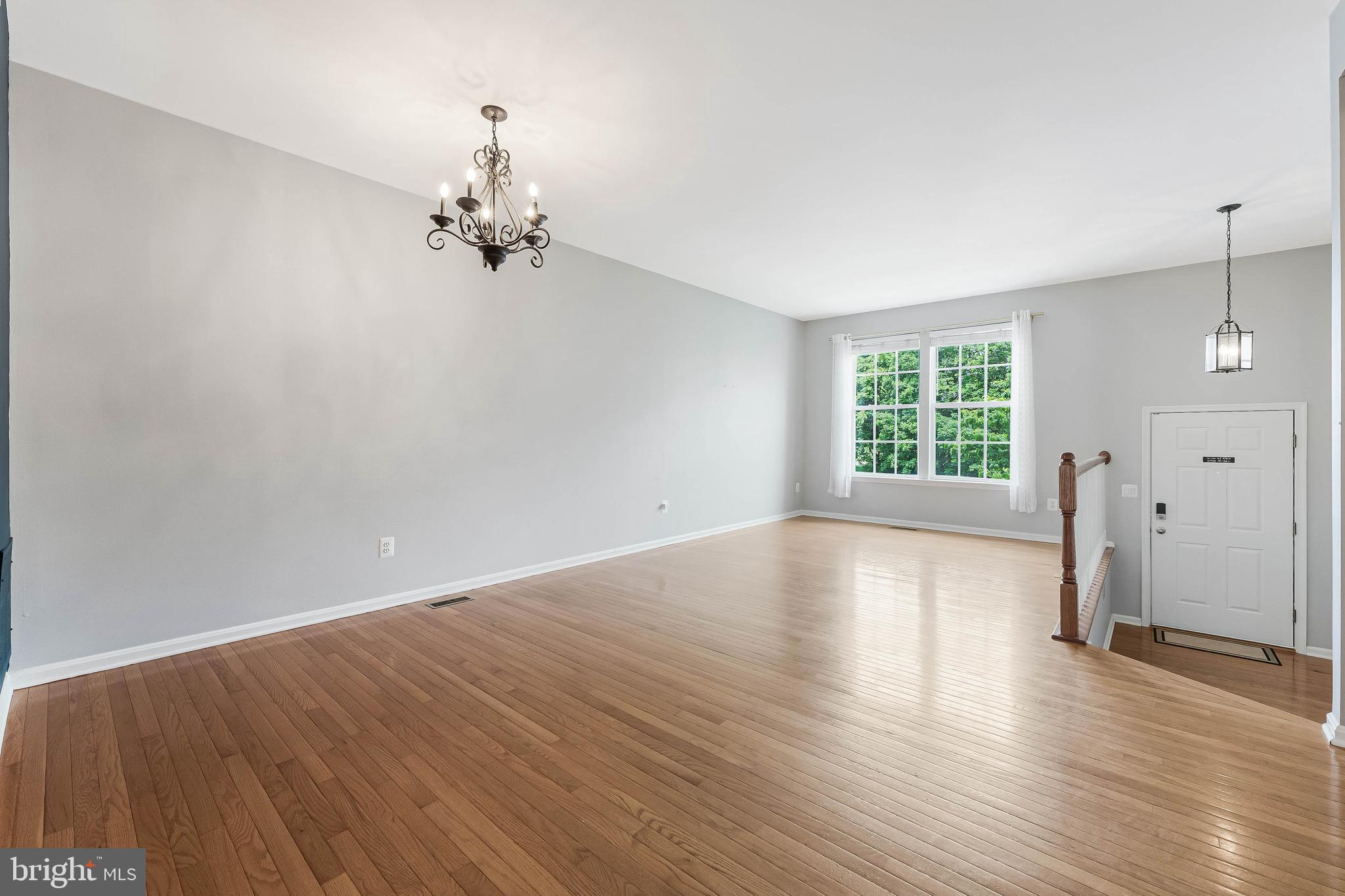 43103 Forest Edge Square Broadlands, VA 20148 - Photo 8 of 57 an empty room with wooden floor and windows