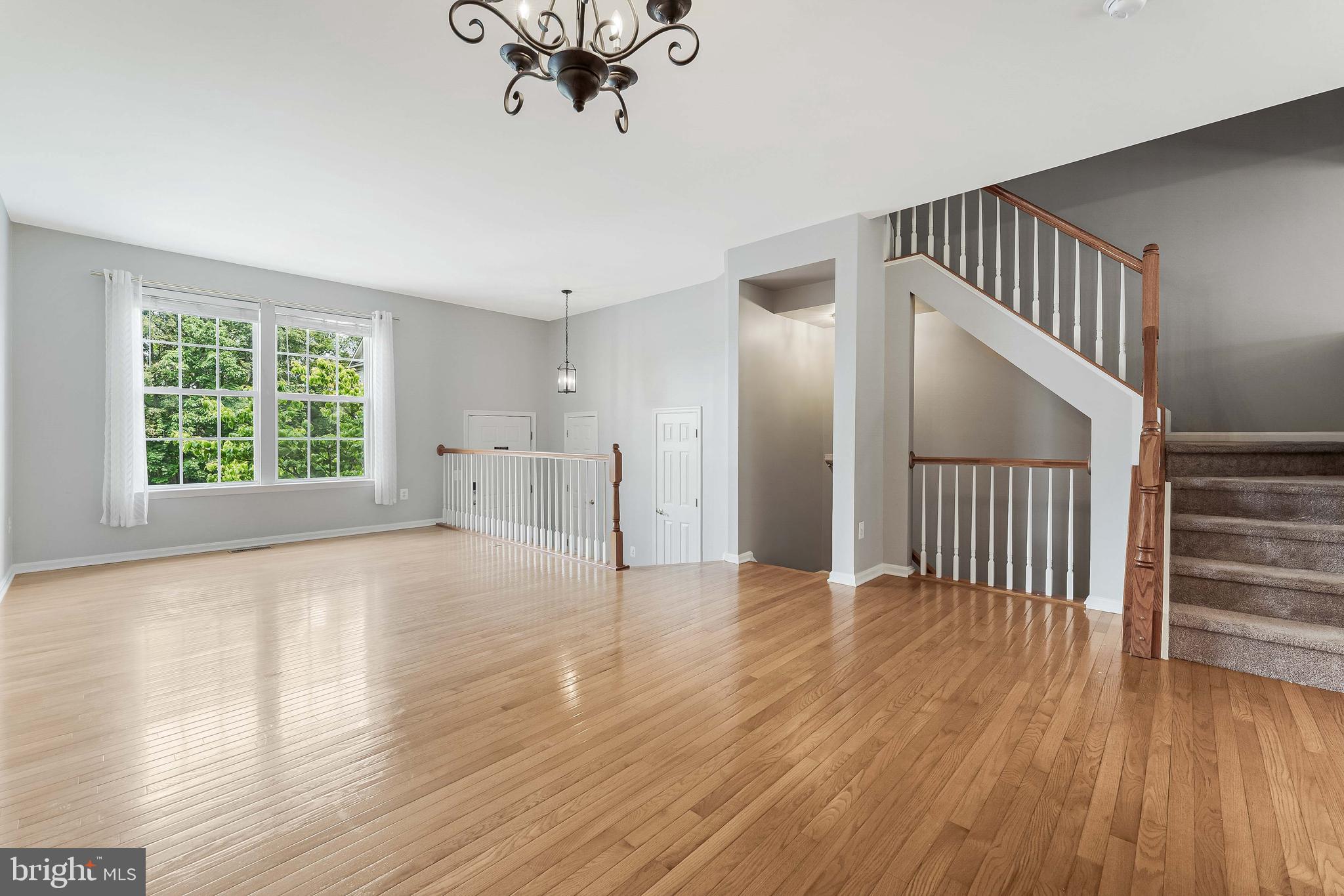 43103 Forest Edge Square Broadlands, VA 20148 - Photo 9 of 57 wooden floor in an empty room with a window