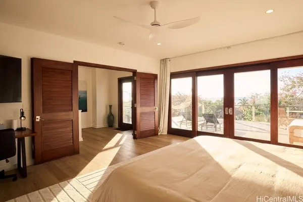 a spacious bedroom with a large bed and a large window