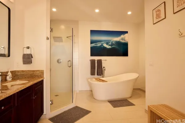 a spacious bathroom with a bathtub sink and mirror