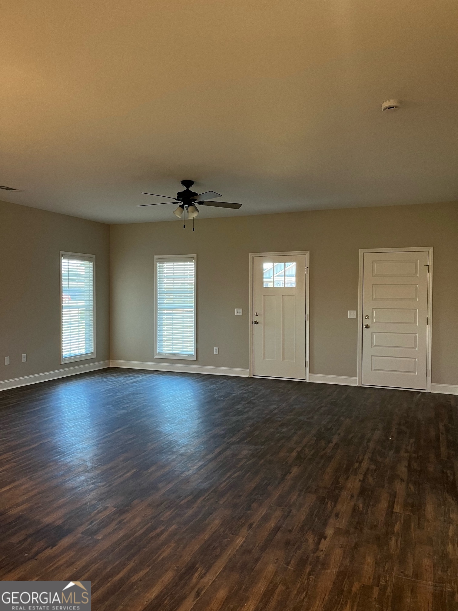 129 Orchard Way Brooklet, GA 30415 - Photo 2 of 15 an empty room with wooden floor and windows