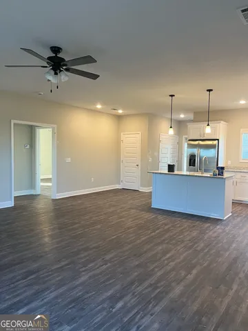 a view of a kitchen with a sink and a ceiling fan
