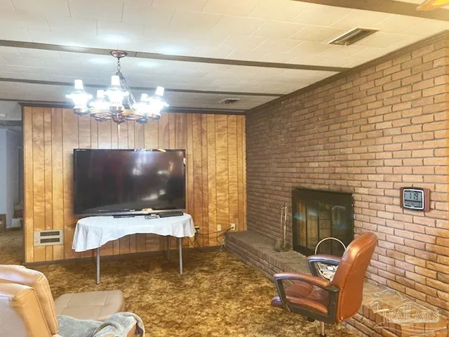 a living room with furniture a dining table and a flat screen tv