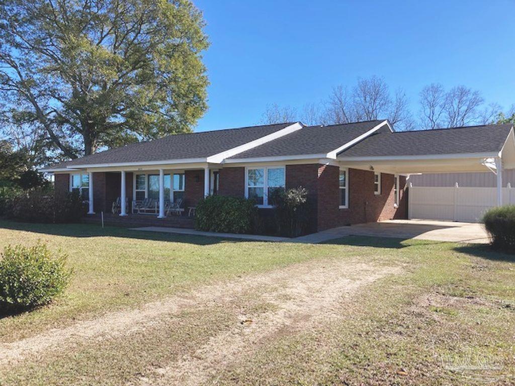 9870 Highway 31 Atmore, AL 36502 - Photo 2 of 31 a front view of a house with a yard