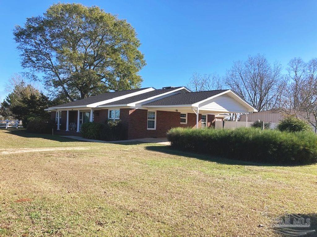 9870 Highway 31 Atmore, AL 36502 - Photo 3 of 31 a front view of a house with a yard