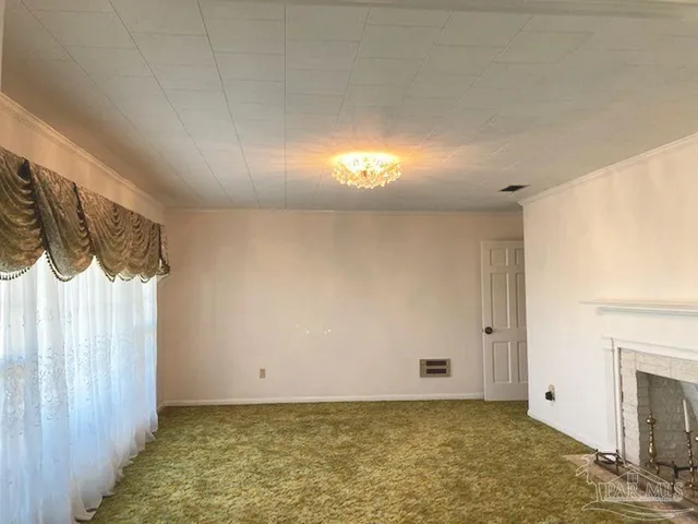 a view of an empty room and a fireplace