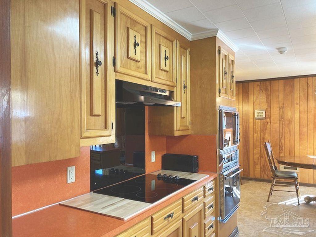 9870 Highway 31 Atmore, AL 36502 - Photo 7 of 31 a kitchen with stainless steel appliances granite countertop a sink and a refrigerator