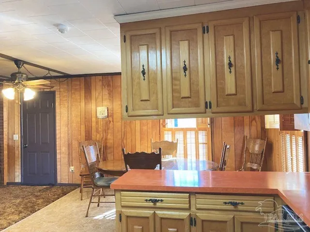 a kitchen with stainless steel appliances wooden cabinets and a table