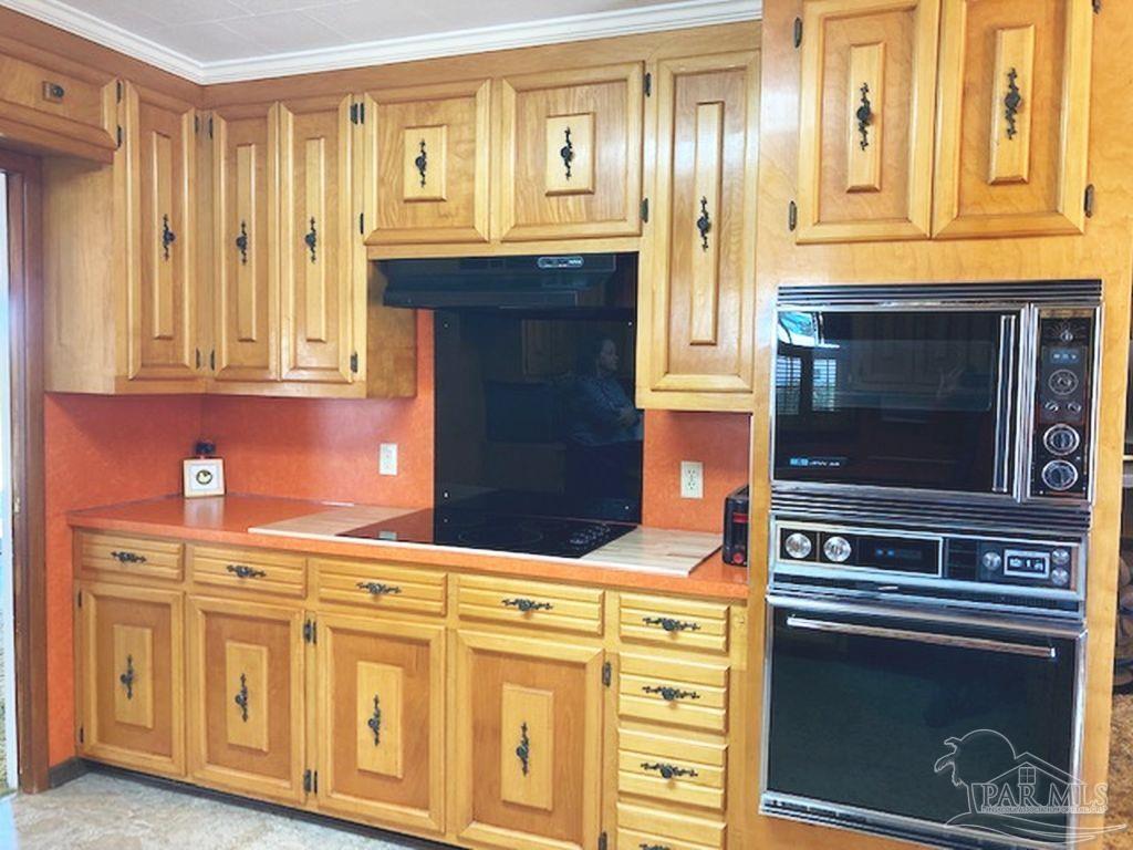 9870 Highway 31 Atmore, AL 36502 - Photo 9 of 31 a kitchen with stainless steel appliances granite countertop a stove and a microwave