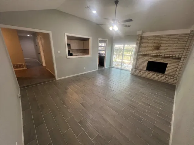 wooden floor in an empty room with a fireplace