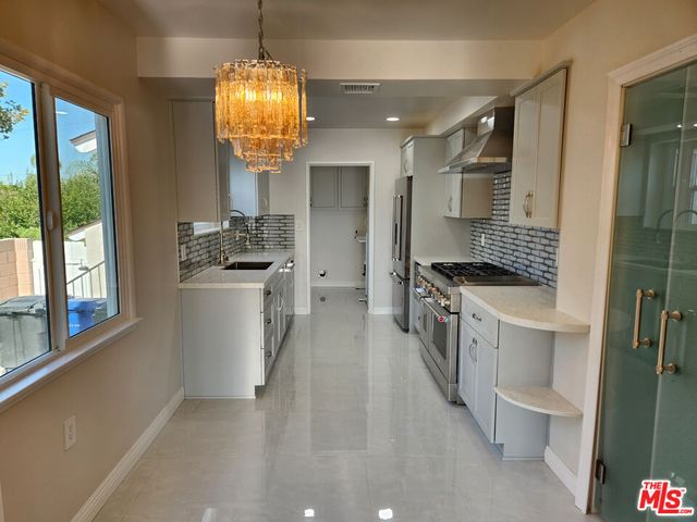 a kitchen with a sink stove and refrigerator