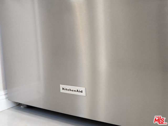 a view of a room with wooden floor and white walls