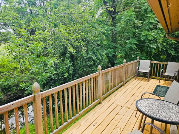 a view of balcony with wooden floor and outdoor seating