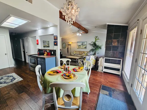 a dining room with furniture and a kitchen view