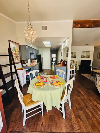 a kitchen with stainless steel appliances a stove and wooden floor