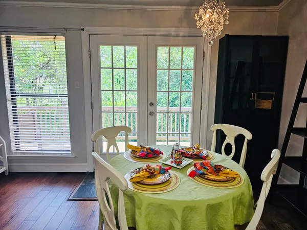 a view of a dining room with furniture and chandelier