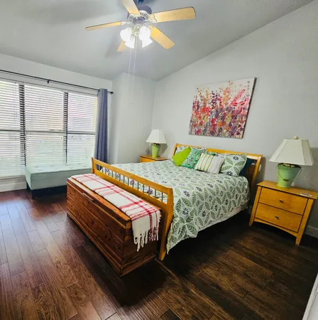 a bedroom with bed and a chandelier
