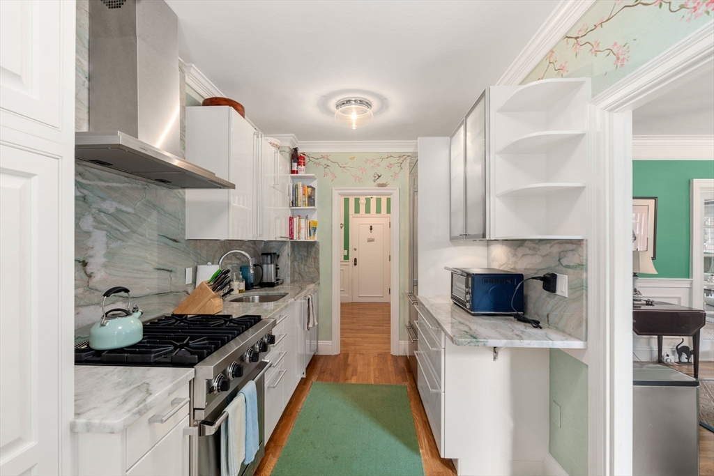 50 Commonwealth Avenue, Unit 204 Boston, MA 02116 - Photo 11 of 21 a kitchen with stainless steel appliances granite countertop a stove and a refrigerator