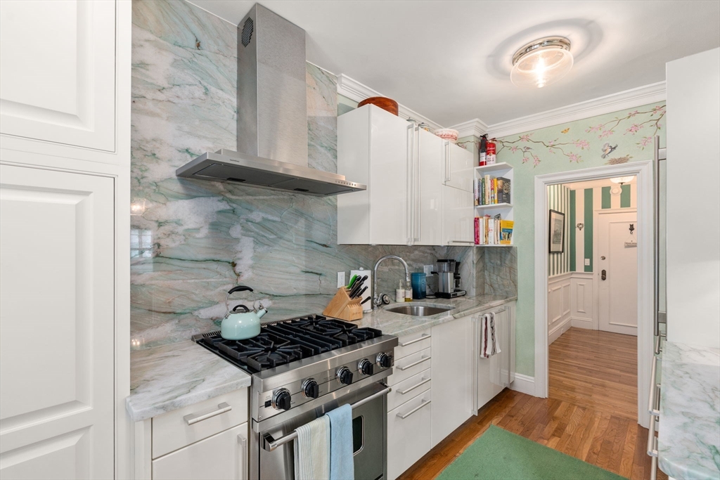50 Commonwealth Avenue, Unit 204 Boston, MA 02116 - Photo 12 of 21 a kitchen with a stove and a refrigerator