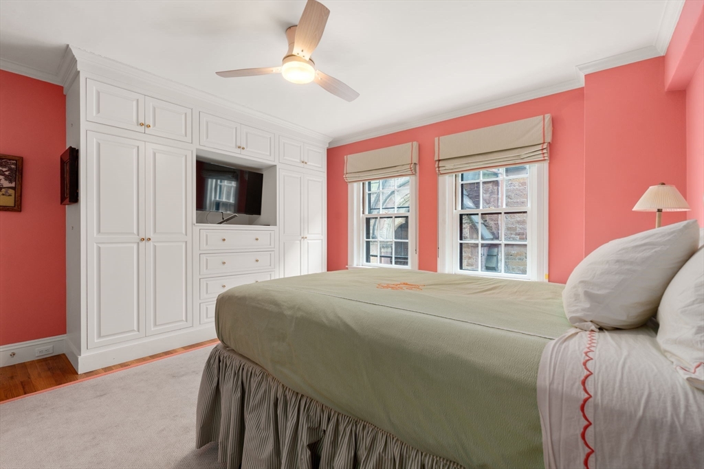 50 Commonwealth Avenue, Unit 204 Boston, MA 02116 - Photo 15 of 21 a bedroom with a bed a tv and wooden floor