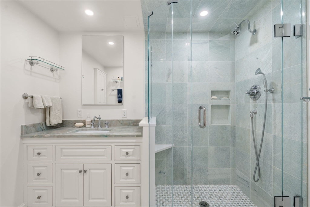 50 Commonwealth Avenue, Unit 204 Boston, MA 02116 - Photo 16 of 21 a bathroom with a granite countertop sink mirror and shower