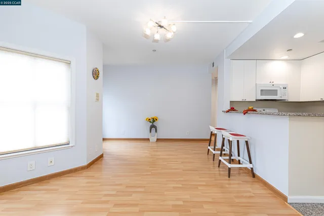 a workspace with wooden floor and natural light