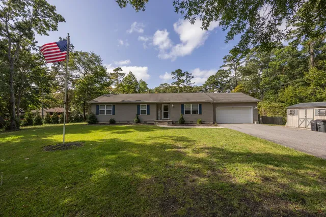 a front view of a house with a big yard