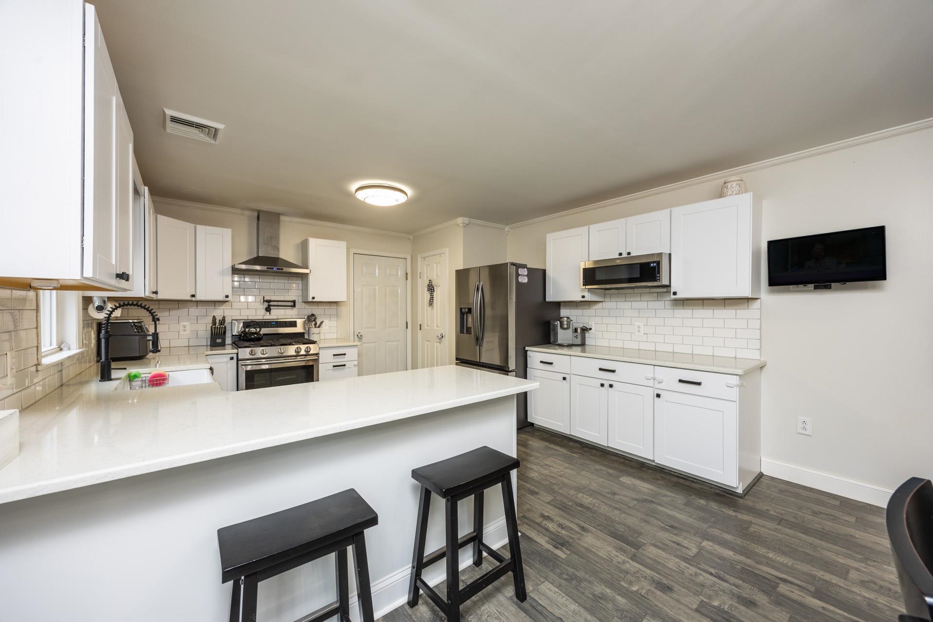 405 Old Goshen Road Ocean View, NJ 08230 - Photo 16 of 38 a kitchen with stainless steel appliances a refrigerator stove microwave and cabinets