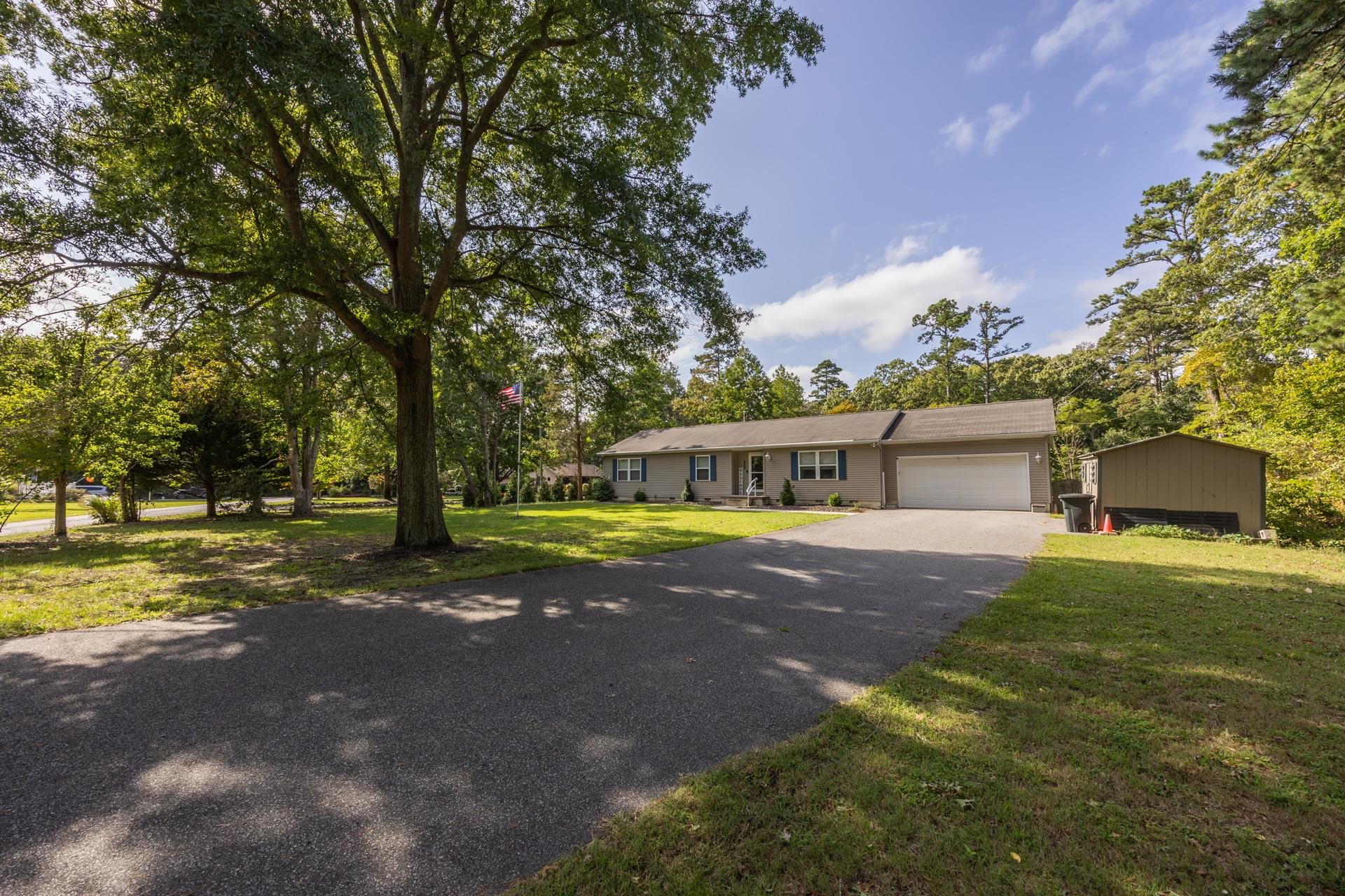 405 Old Goshen Road Ocean View, NJ 08230 - Photo 2 of 38 a view of a house with a yard and garage