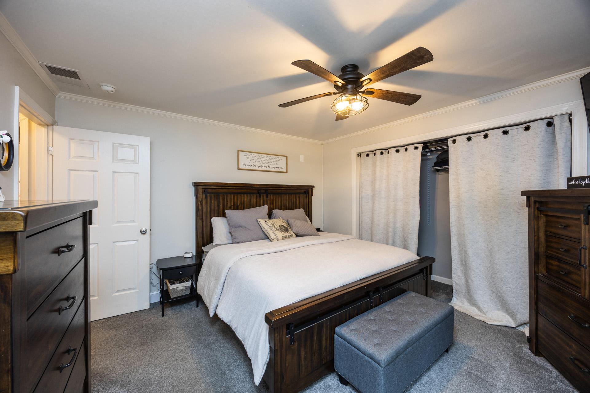 405 Old Goshen Road Ocean View, NJ 08230 - Photo 27 of 38 a bedroom with a bed and a chandelier