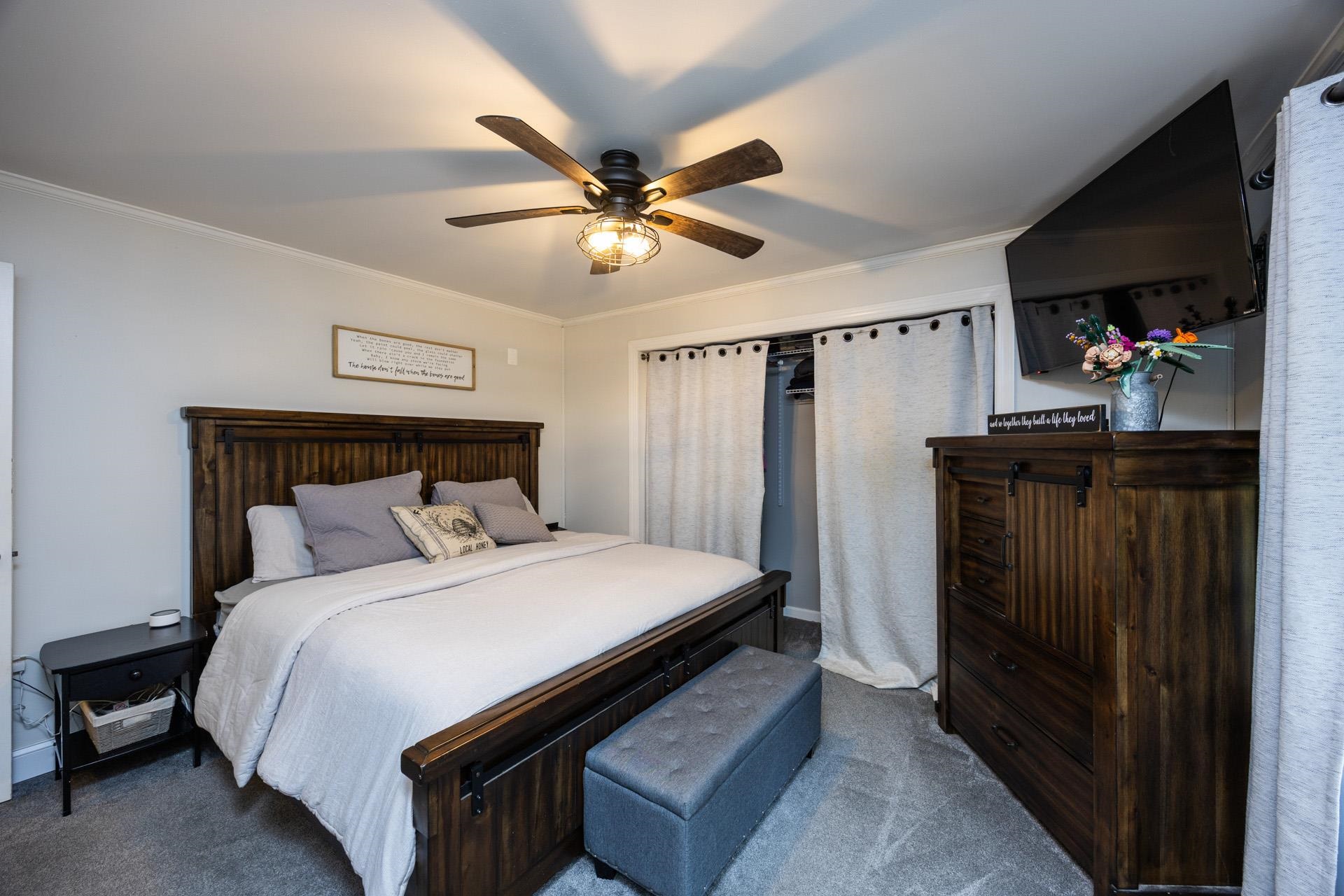 405 Old Goshen Road Ocean View, NJ 08230 - Photo 29 of 38 a bedroom with a bed and a flat tv screen