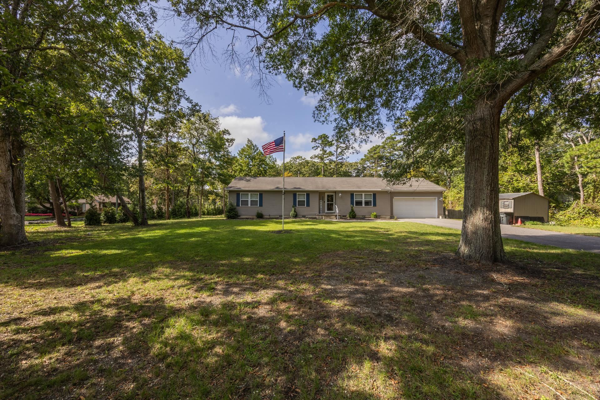 405 Old Goshen Road Ocean View, NJ 08230 - Photo 3 of 38 a front view of a house with a garden