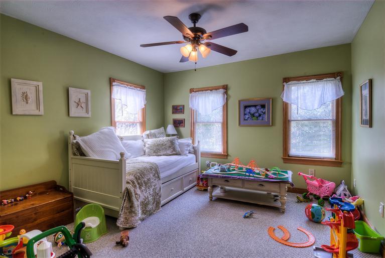 200 Evergreen Drive Marstons Mills, MA 02648 - Photo 11 of 25 a bedroom with furniture and a chandelier