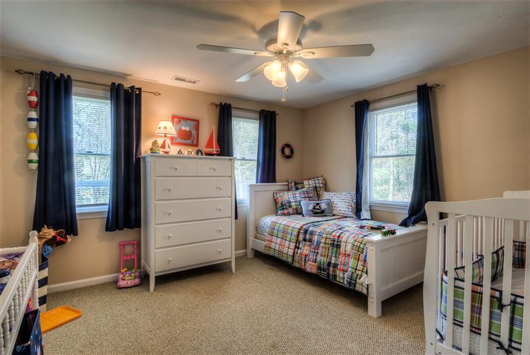 200 Evergreen Drive Marstons Mills, MA 02648 - Photo 16 of 25 a bedroom with a bed and a baby crib