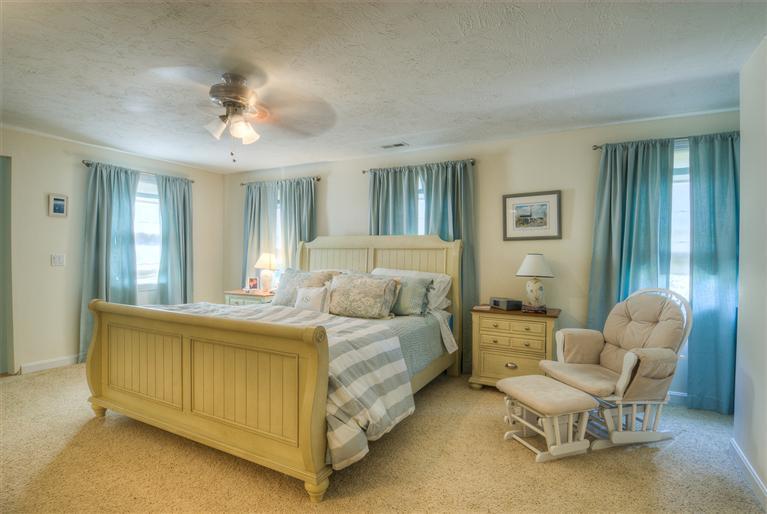 200 Evergreen Drive Marstons Mills, MA 02648 - Photo 17 of 25 a bedroom with a bed and a chandelier