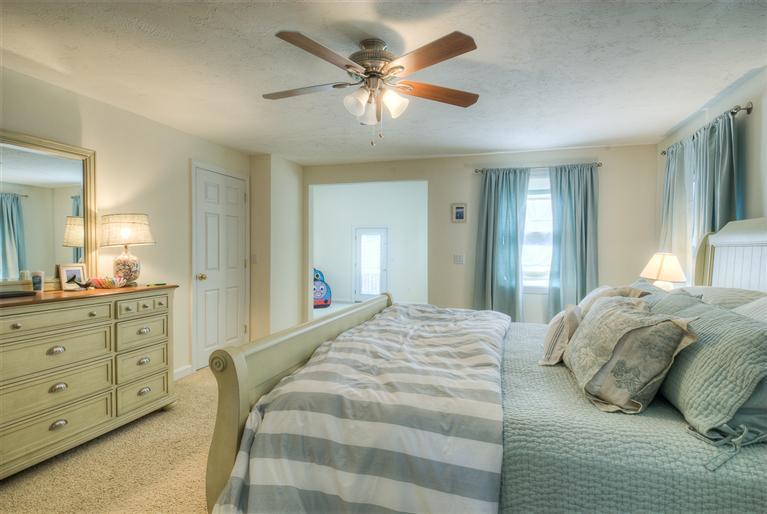 200 Evergreen Drive Marstons Mills, MA 02648 - Photo 18 of 25 a bedroom with a bed and ceiling fan