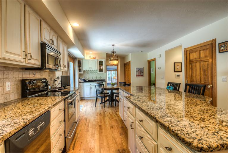 200 Evergreen Drive Marstons Mills, MA 02648 - Photo 9 of 25 a kitchen with stainless steel appliances granite countertop sink stove top oven and cabinets