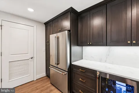 a kitchen with a refrigerator and cabinets